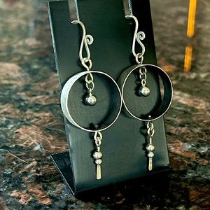 Sterling silver drop hoop earrings.